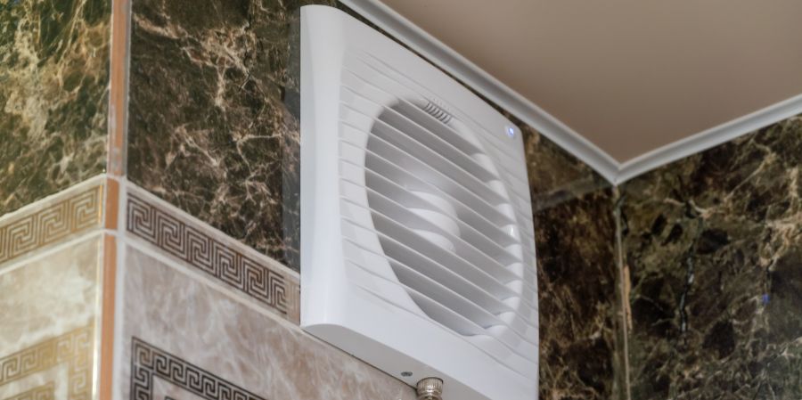 Bathroom exhaust fan installed on a tile wall